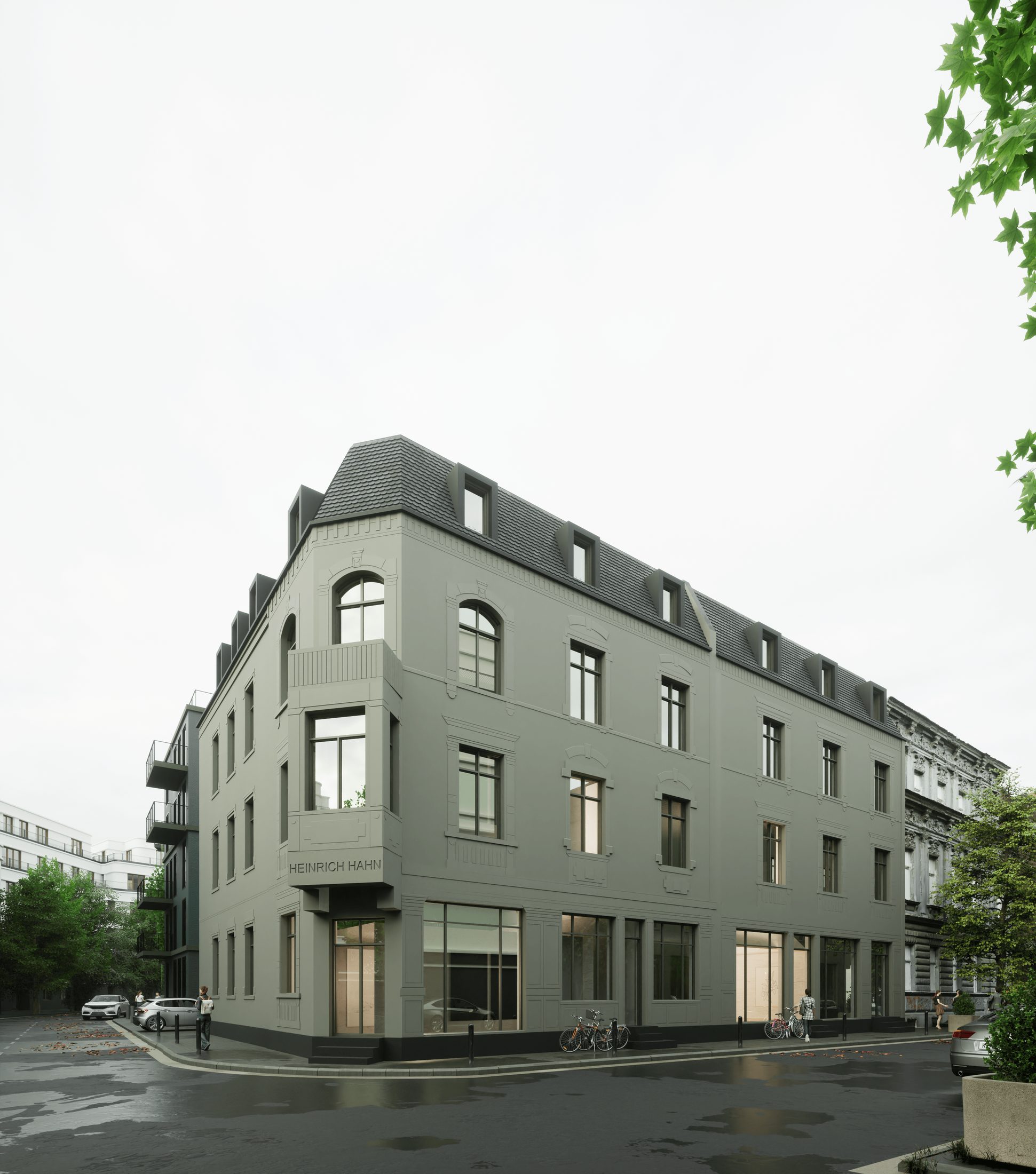 Graues Eckgebäude im Bestand mit Gauben
