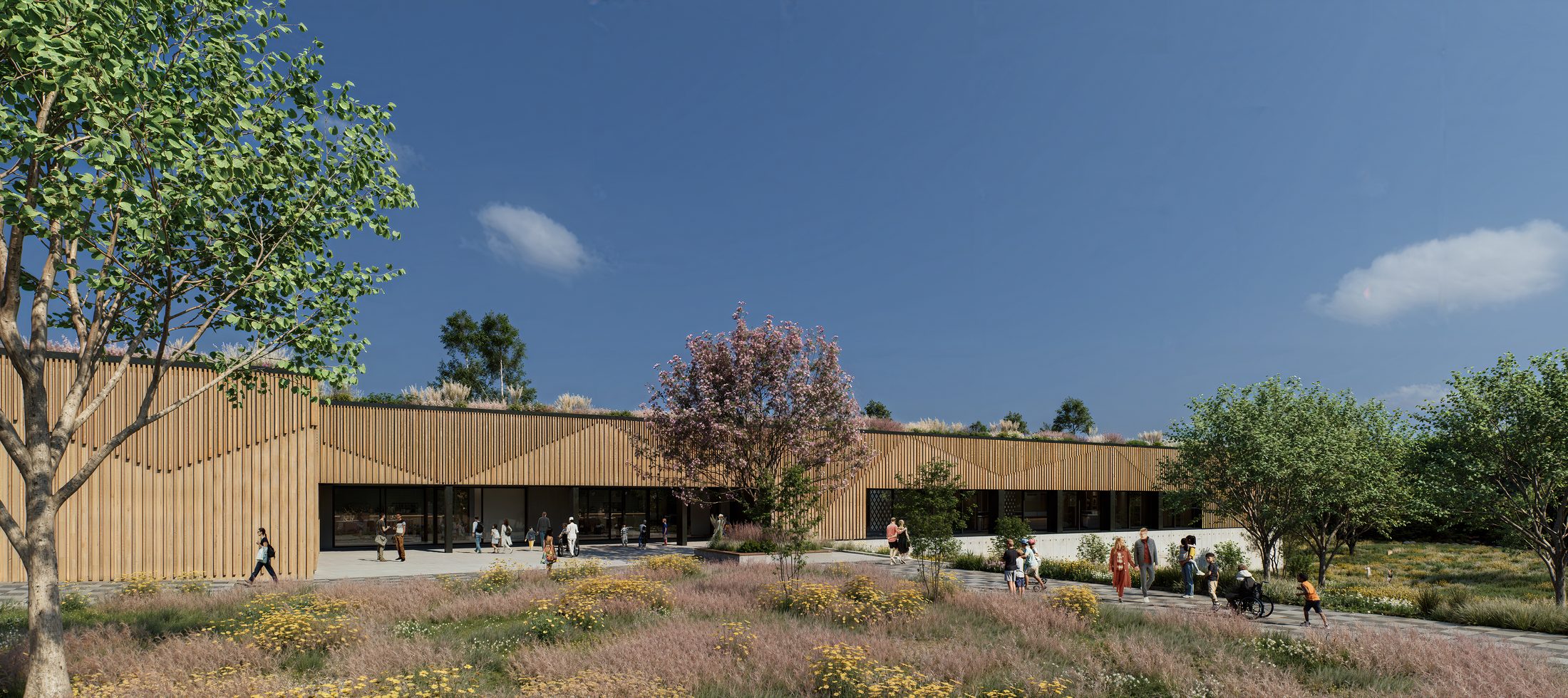 Holzfassade mit blühendem Baum und Gräsern